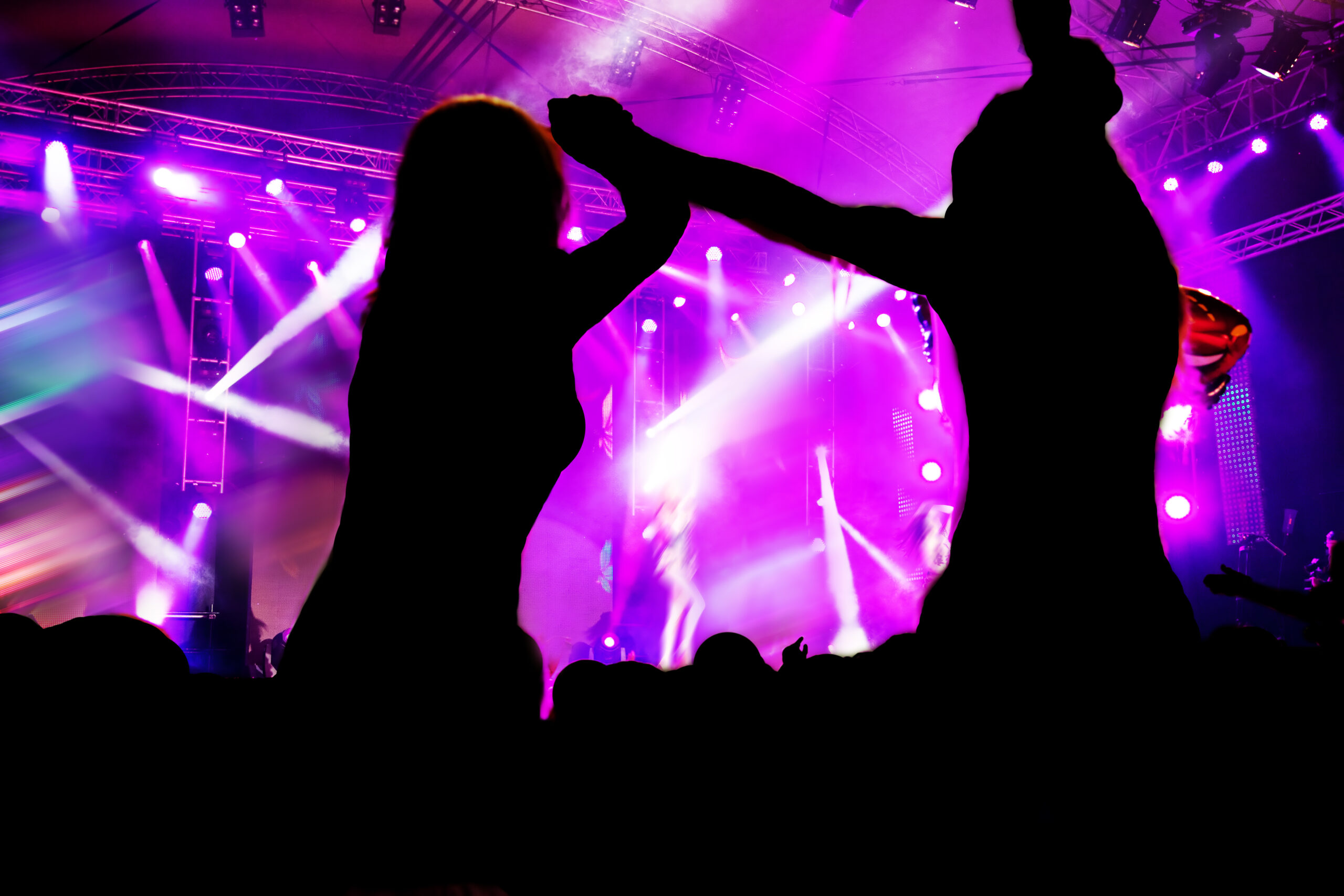 People dancing at a party with concert lighting