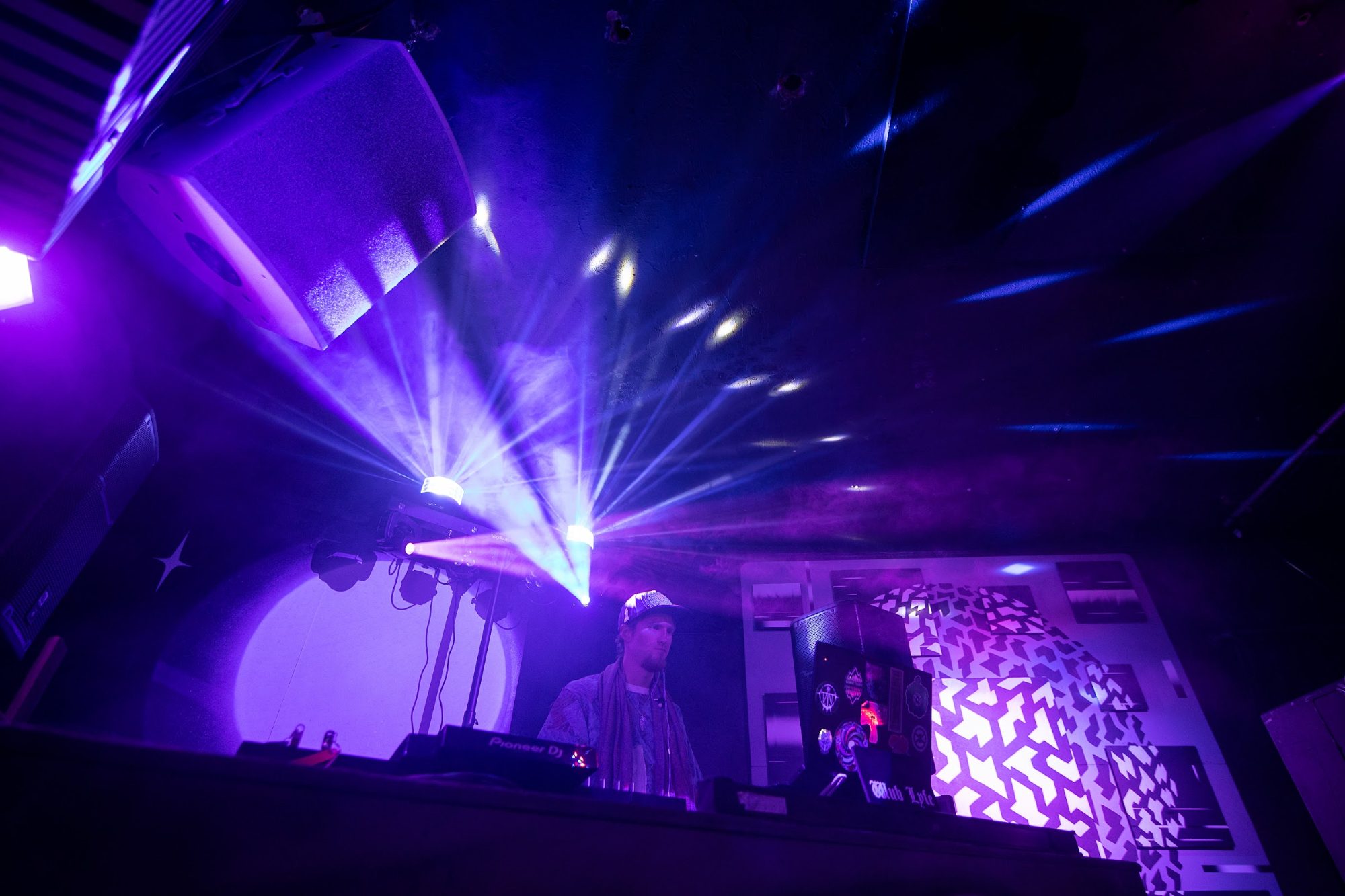 Moving-head lights sweeping over the DJ booth at PULSE, Oct 10, 2026