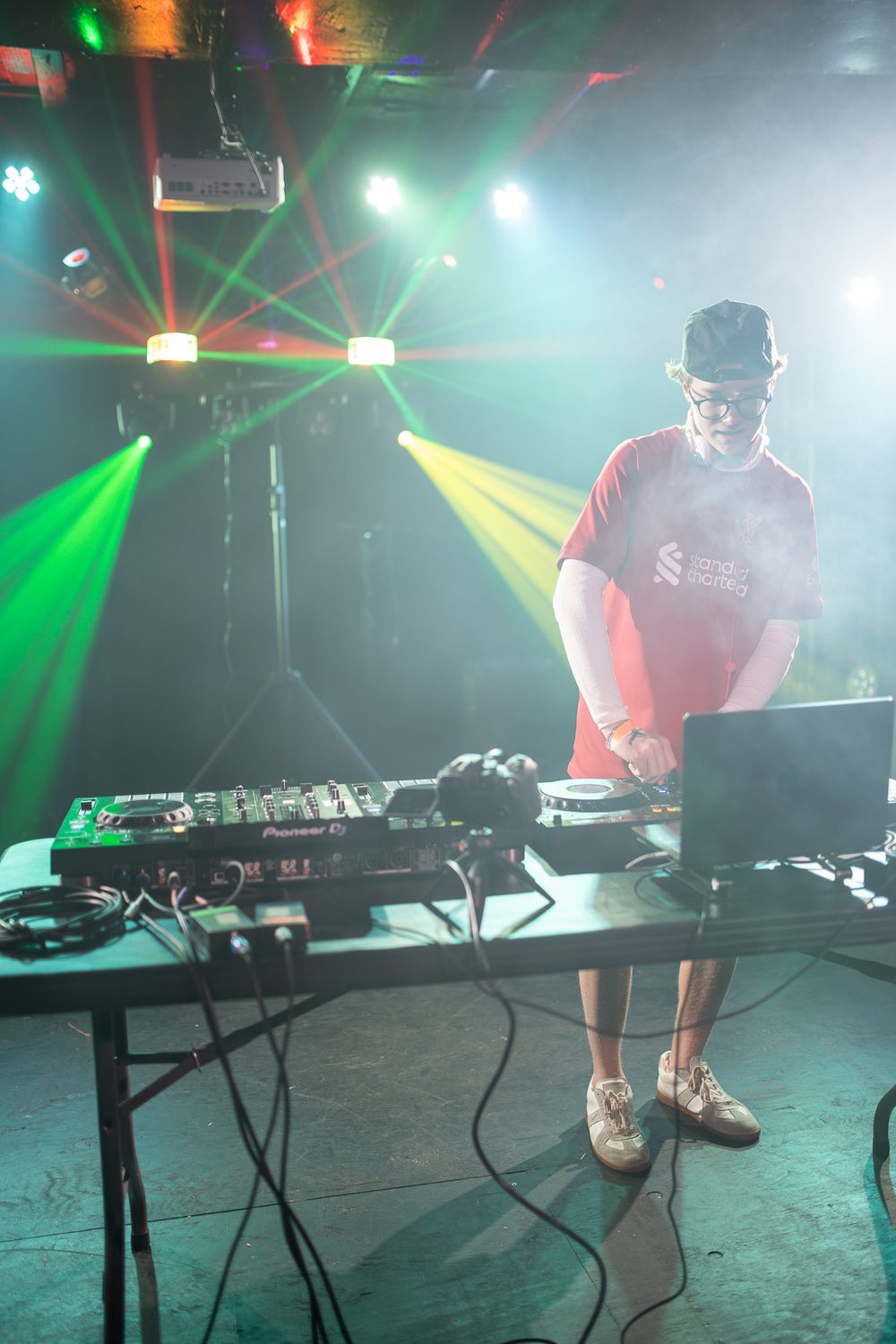 Live DJ set under stage lasers at a Resonant District show